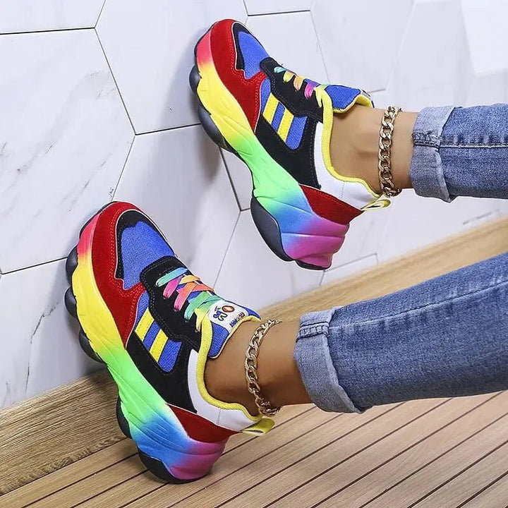 Vibrant women's lace-up platform sneakers with eye-catching rainbow sole, offering comfortable and wide fit for daily wear.