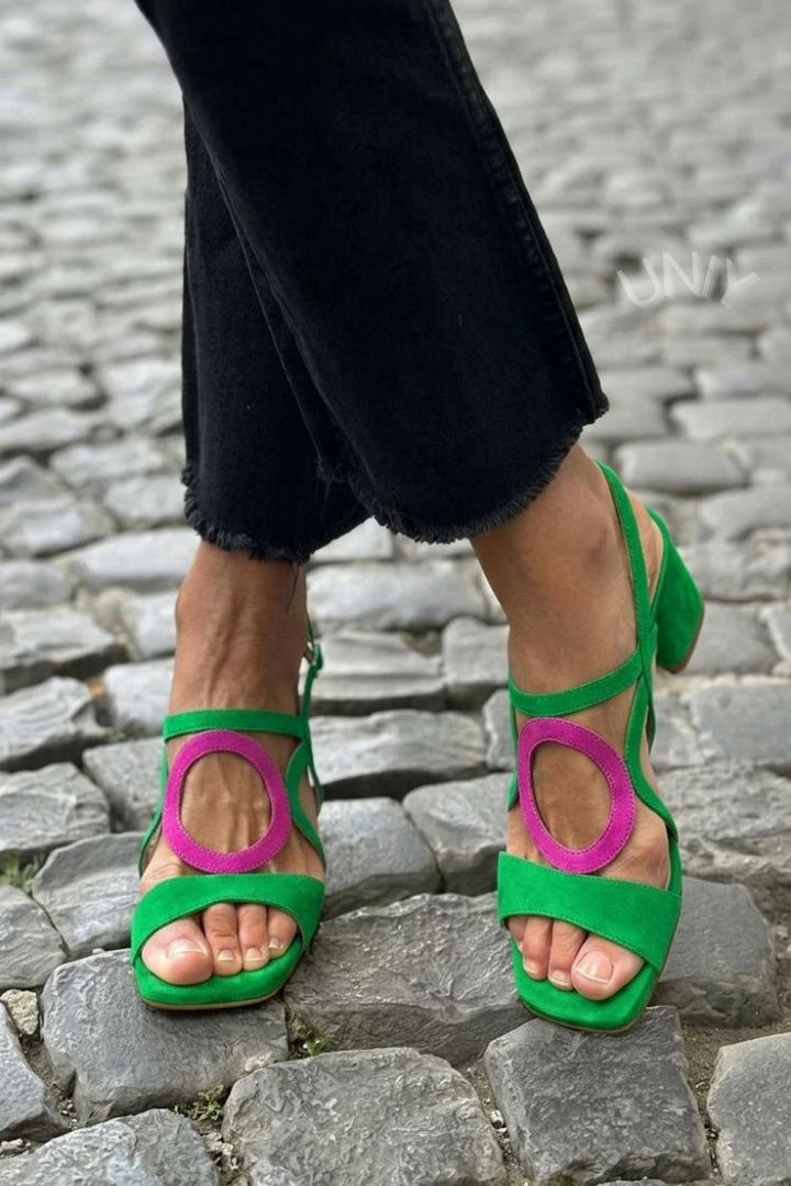 Stylish women's summer sandals, heeled with a distinctive circular embellishment.