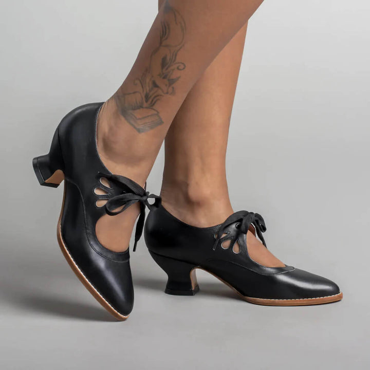 Women's vintage black Mary Jane shoes with comfortable block heels, perfect for retro pin-up style.