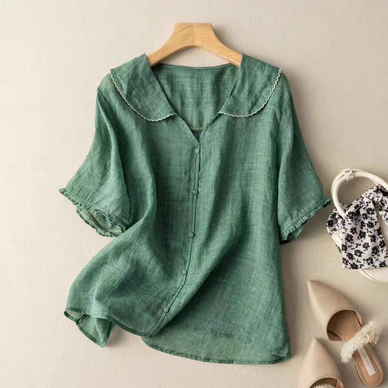 Women's vintage blouse with delicate button detail, offering an elegant & effortless style for casual wear.