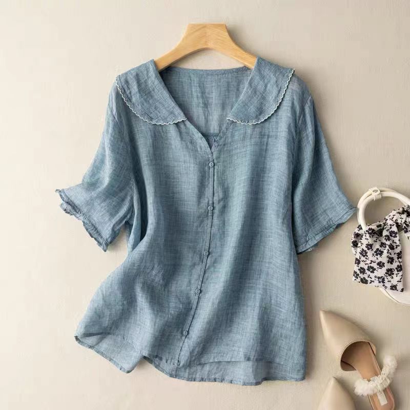 Lightweight feminine vintage blouse with chic button detail, perfect for a comfortable and stylish look.