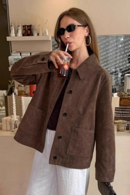Brown women's jacket, vintage style, with a prominent notched lapel & long sleeves for a classic, elegant appearance.