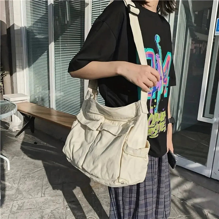 Detailed view of durable canvas multi-pocket vintage women's handbag. Can be worn as a crossbody or shoulder tote.