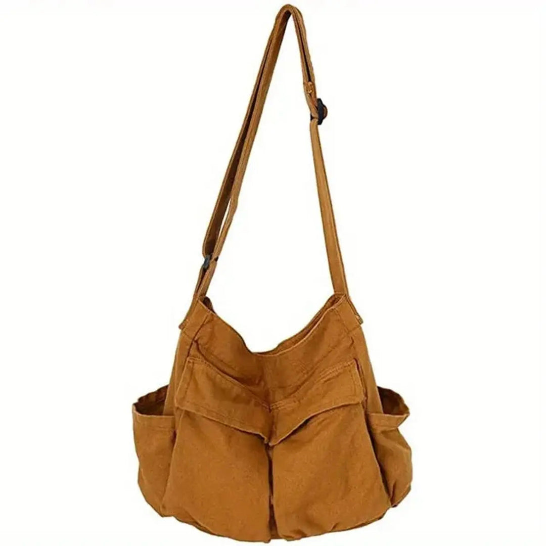 Close-up of a multi-pocket on the vintage women's canvas crossbody tote bag. Durable and functional design.