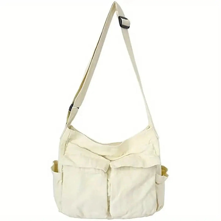 Woman wearing a vintage canvas multi-pocket crossbody tote bag. Casual and stylish women's shoulder handbag.