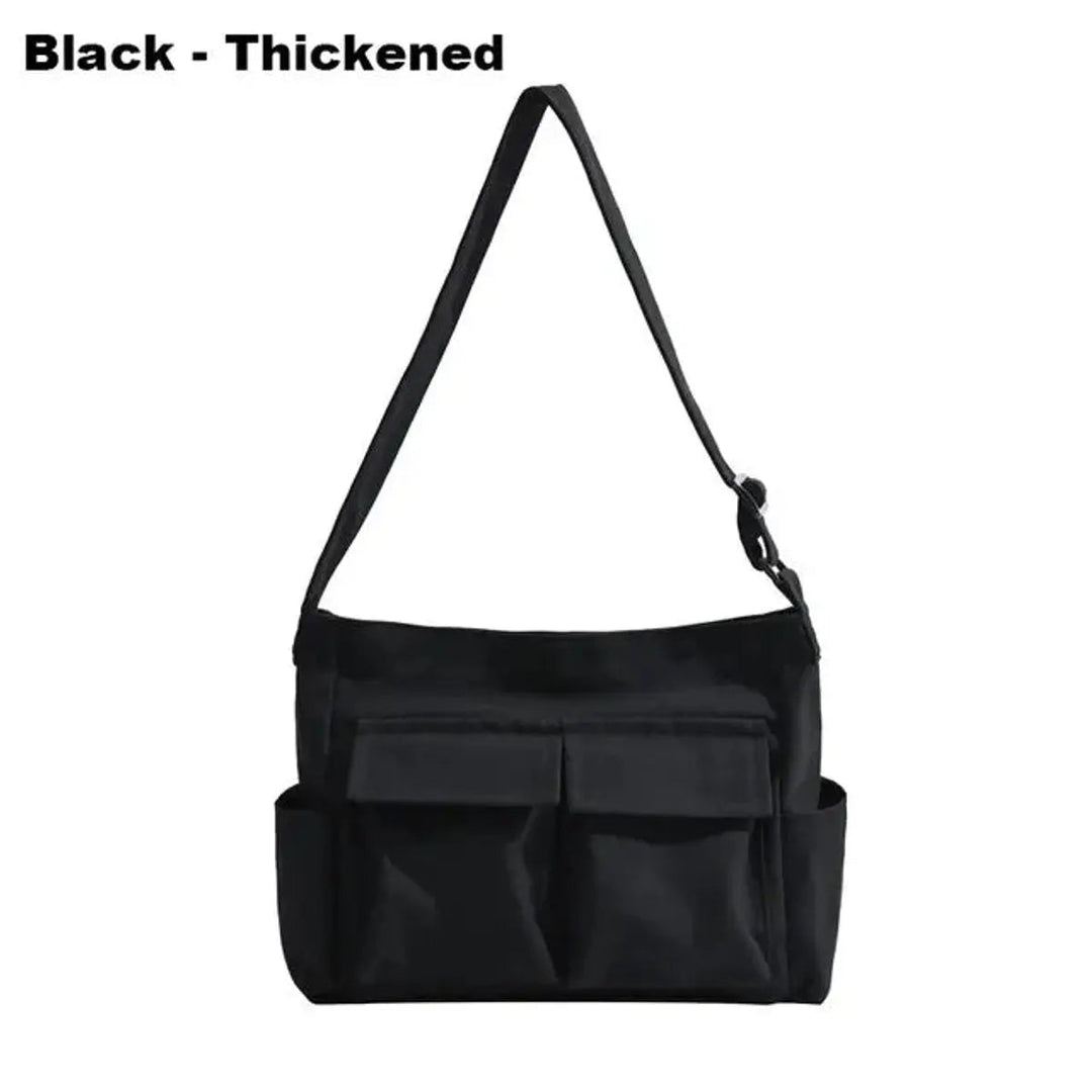 Back view of vintage women's canvas multi-pocket crossbody bag. Durable tote with spacious design for daily use.