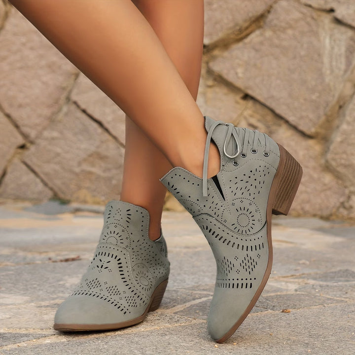 Chic women's vintage-style ankle boots with elegant cutout details & practical side zipper. Fashion-forward.