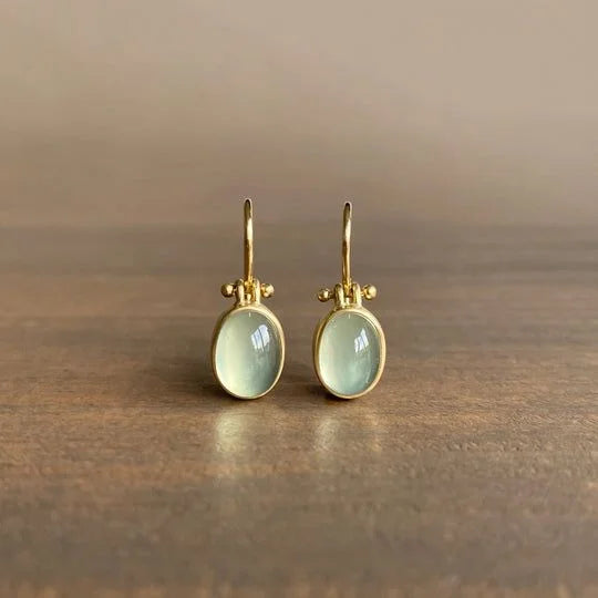 Women's vintage gold-tone green moonstone dangle earrings with lever backs. Elegant statement jewelry.