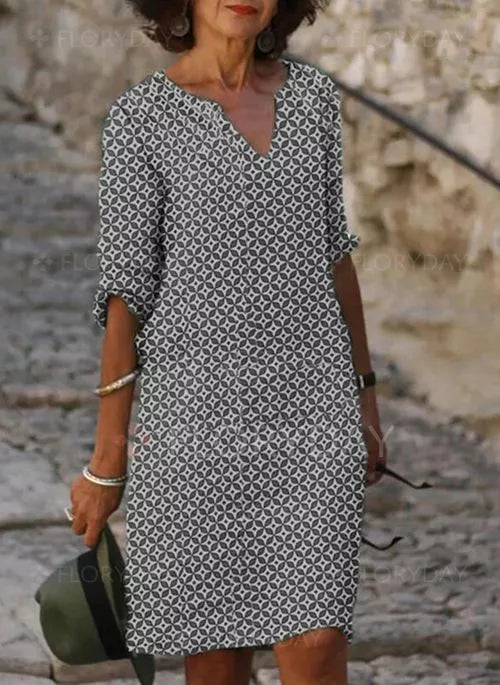 Elegant women's summer midi dress with a vintage split-neck design and flowy fabric, ideal for spring fashion.