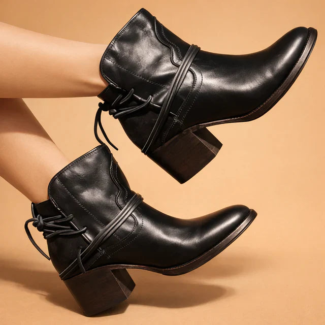 Close-up of women's pointed toe fashion ankle boots with durable thick heel detail