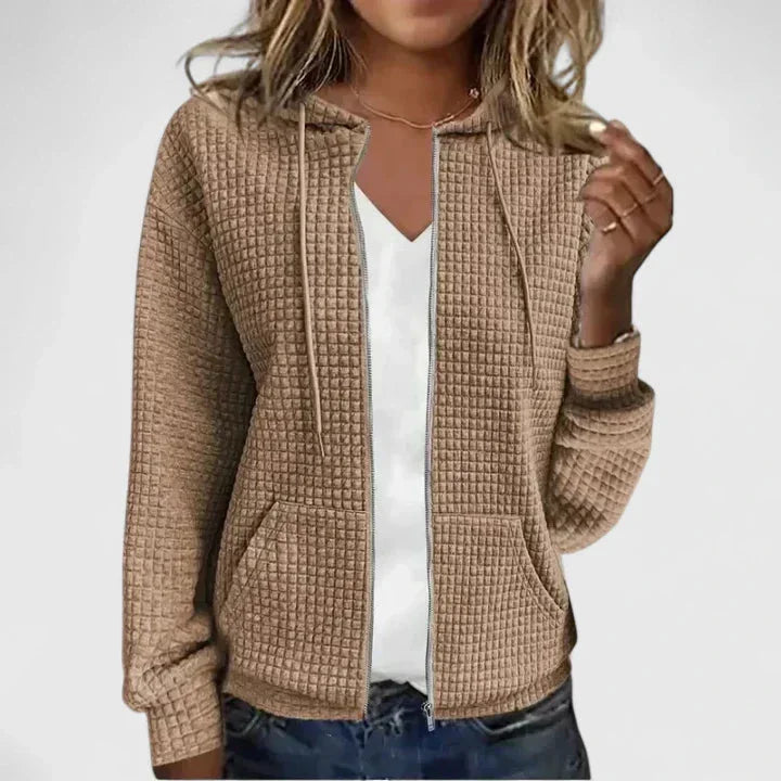 Detailed view of a women's soft waffle-knit hooded cardigan, showcasing full zipper and practical side pockets.