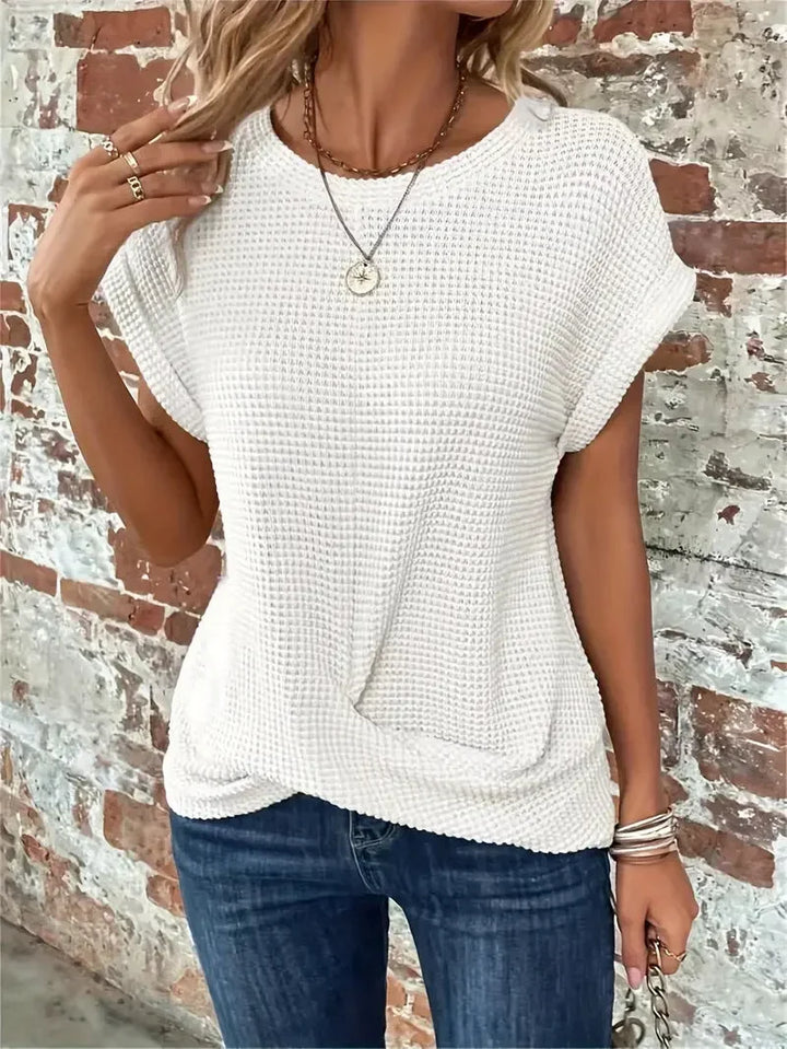 Women's waffle knit short sleeve top with stylish front twist detail, perfect for casual everyday wear.