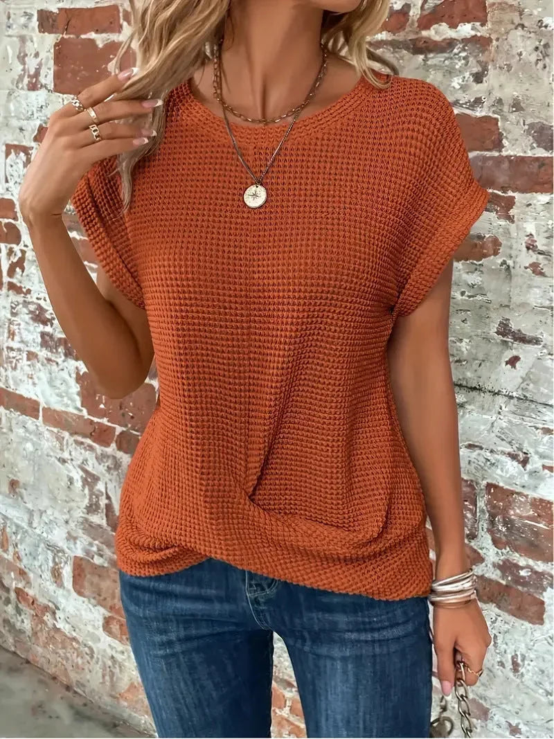 Comfortable women's waffle knit sweater, short sleeve, showcasing an elegant front twist design.