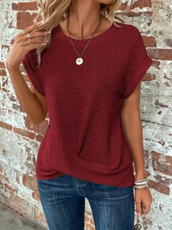 Versatile women's short sleeve waffle knit top with a fashionable front twist, crew neck style.