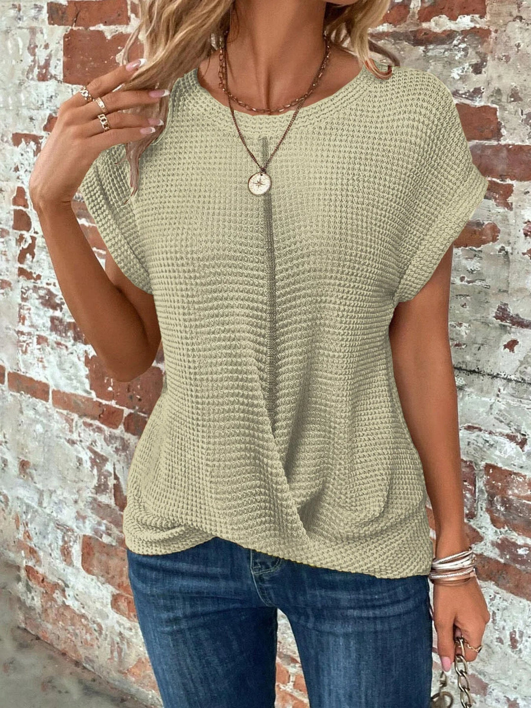 Trendy women's waffle knit short sleeve top, featuring a flattering front twist and relaxed fit.