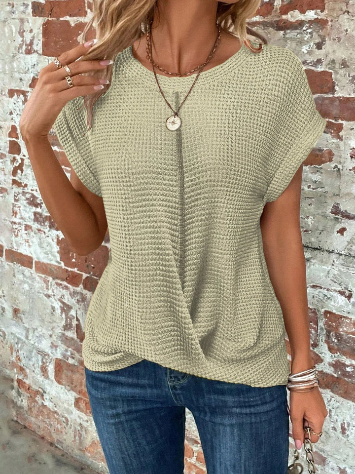 Trendy women's waffle knit short sleeve top, featuring a flattering front twist and relaxed fit.