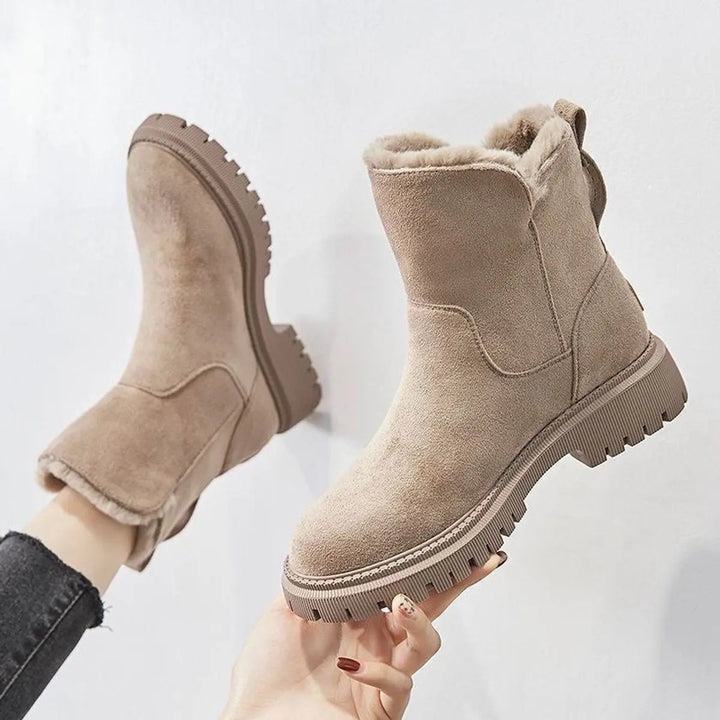 Women's warm fleece-lined slip-on ankle boots with chunky sole, perfect for cold weather comfort.
