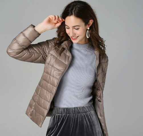 Fashionable women's long sleeve puffer jacket with quilted design, a warm and comfortable winter coat.