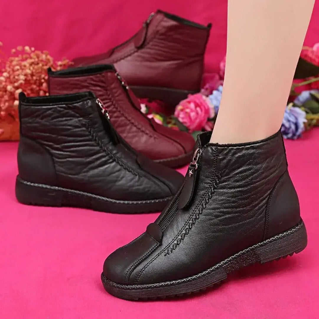 Comfortable women's winter ankle boots with a convenient zip-up closure and non-slip sole for cold weather.