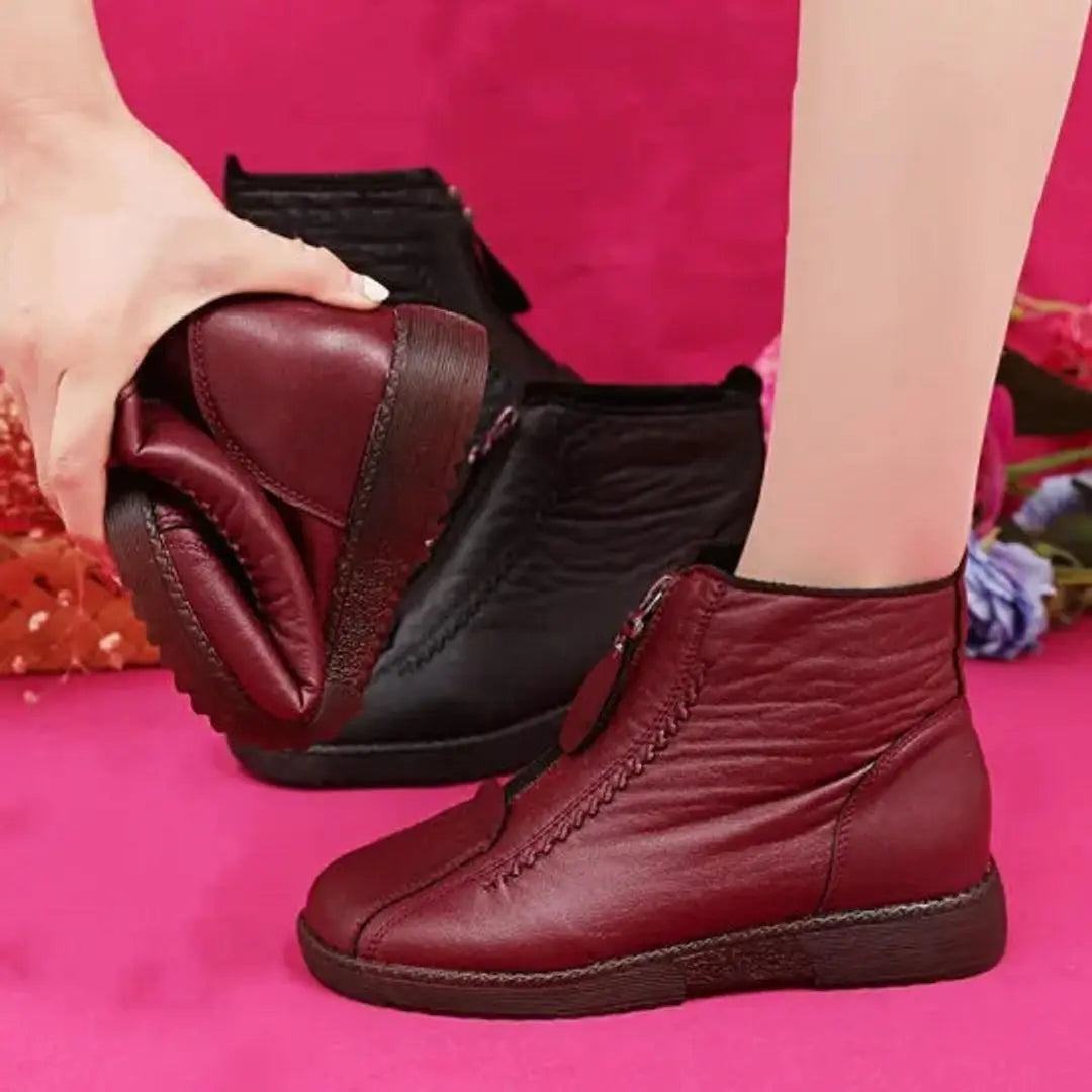 Warm women's zip-up ankle boots, featuring a non-slip sole for secure grip in icy winter conditions.
