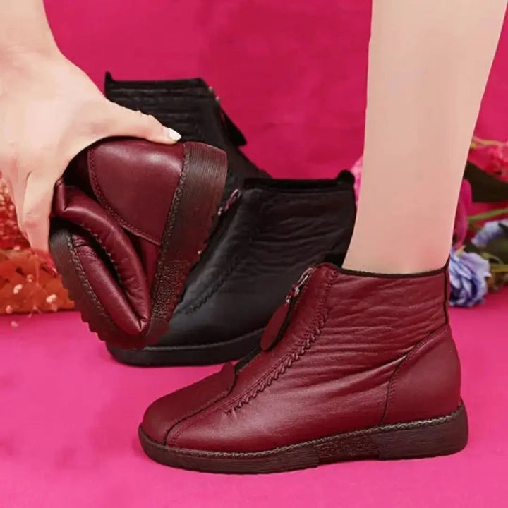 Warm women's zip-up ankle boots, featuring a non-slip sole for secure grip in icy winter conditions.
