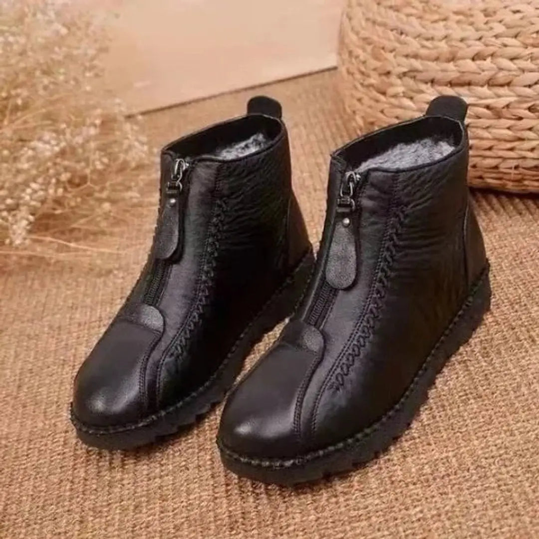 Durable women's winter ankle boots; warm, zip-up design and non-slip sole offer comfort & safety in cold weather.