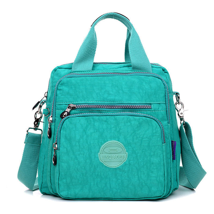Close-up of durable water-resistant material on a women's versatile crossbody shoulder bag.