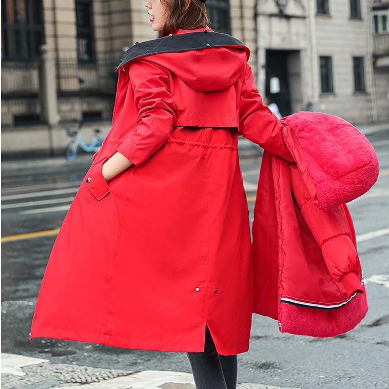 Green women's waterproof hooded jacket, demonstrating its lightweight and versatile nature.