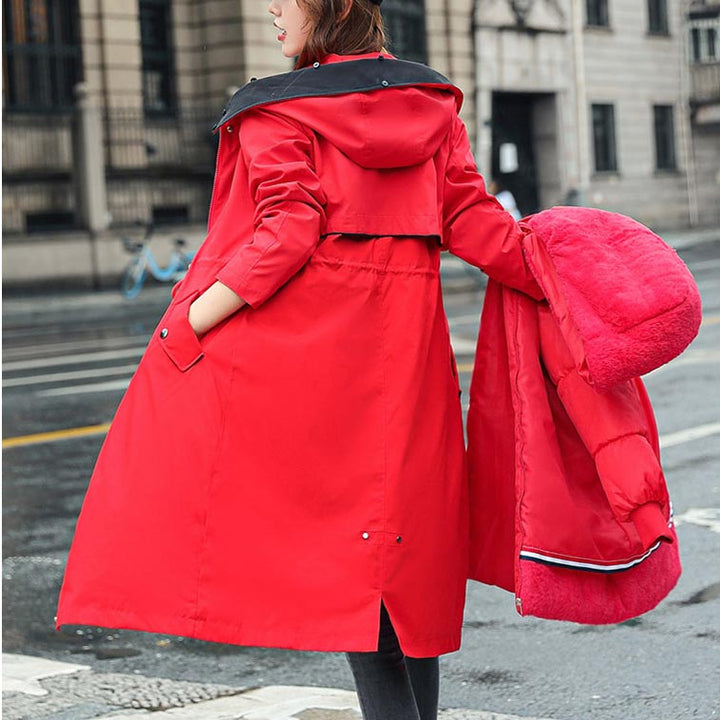 Green women's waterproof hooded jacket, demonstrating its lightweight and versatile nature.