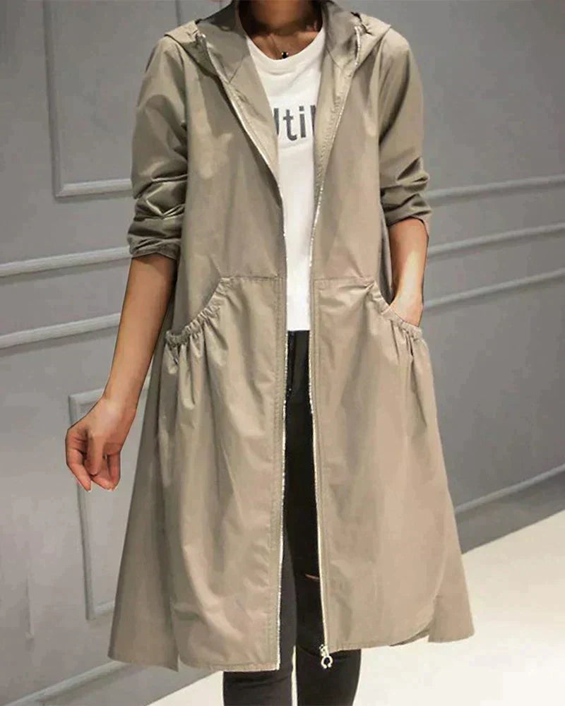 Stylish women's knee-length waterproof jacket with hood, relaxed fit, perfect for fashionable all-weather wear.