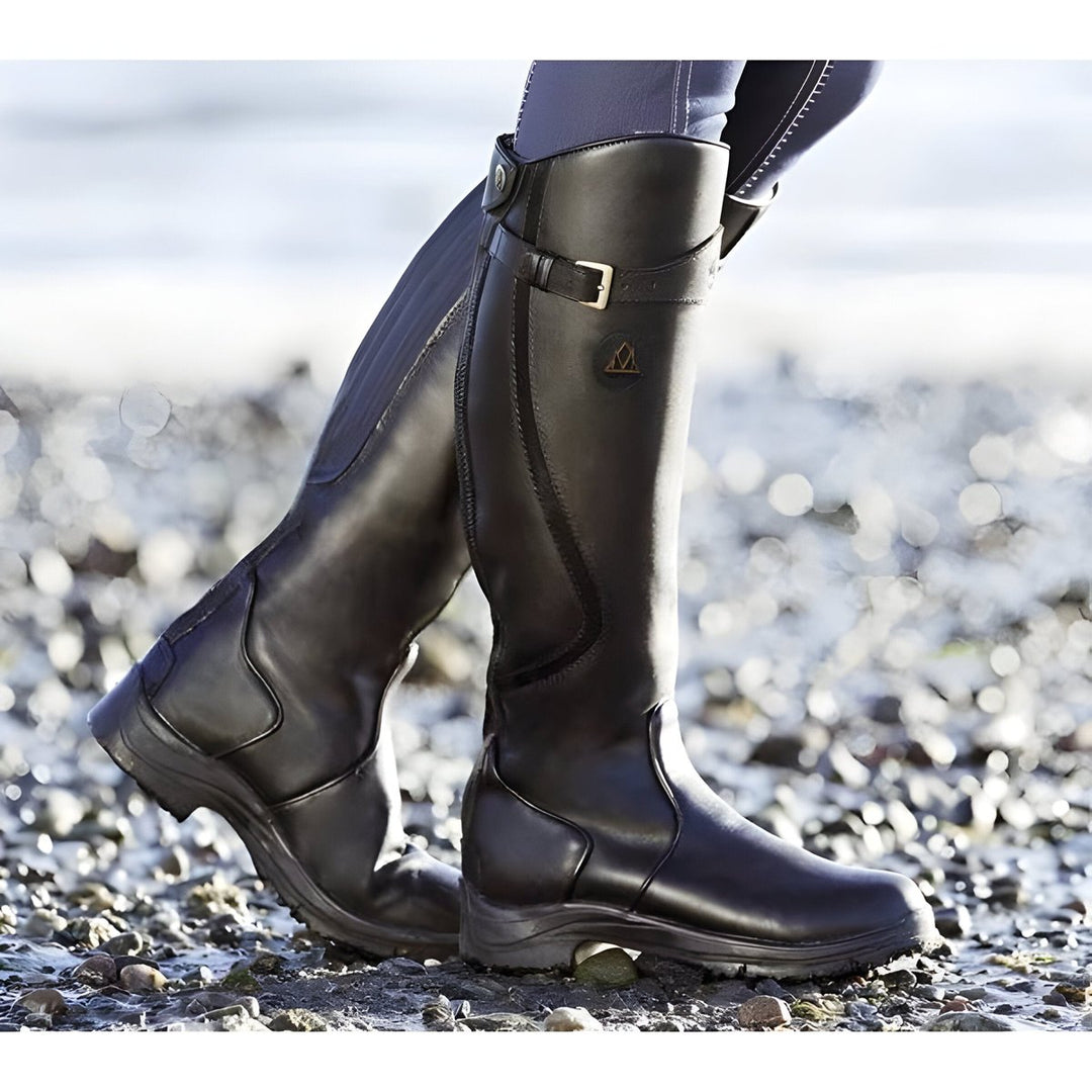 Durable women's waterproof outdoor boots, knee-high with elegant buckle details.