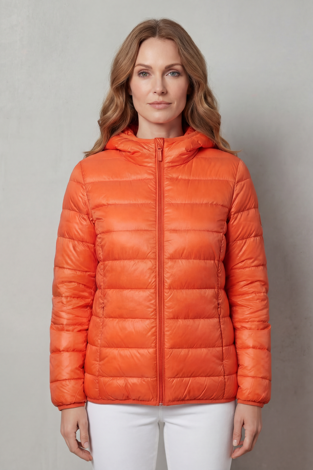 Front view of a women's waterproof rain coat, perfect for layering. Lightweight all-season outerwear for travel.
