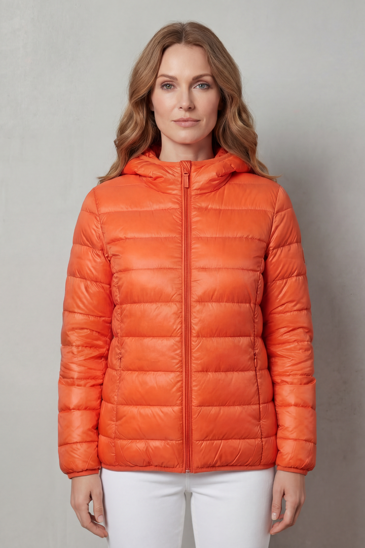 Front view of a women's waterproof rain coat, perfect for layering. Lightweight all-season outerwear for travel.