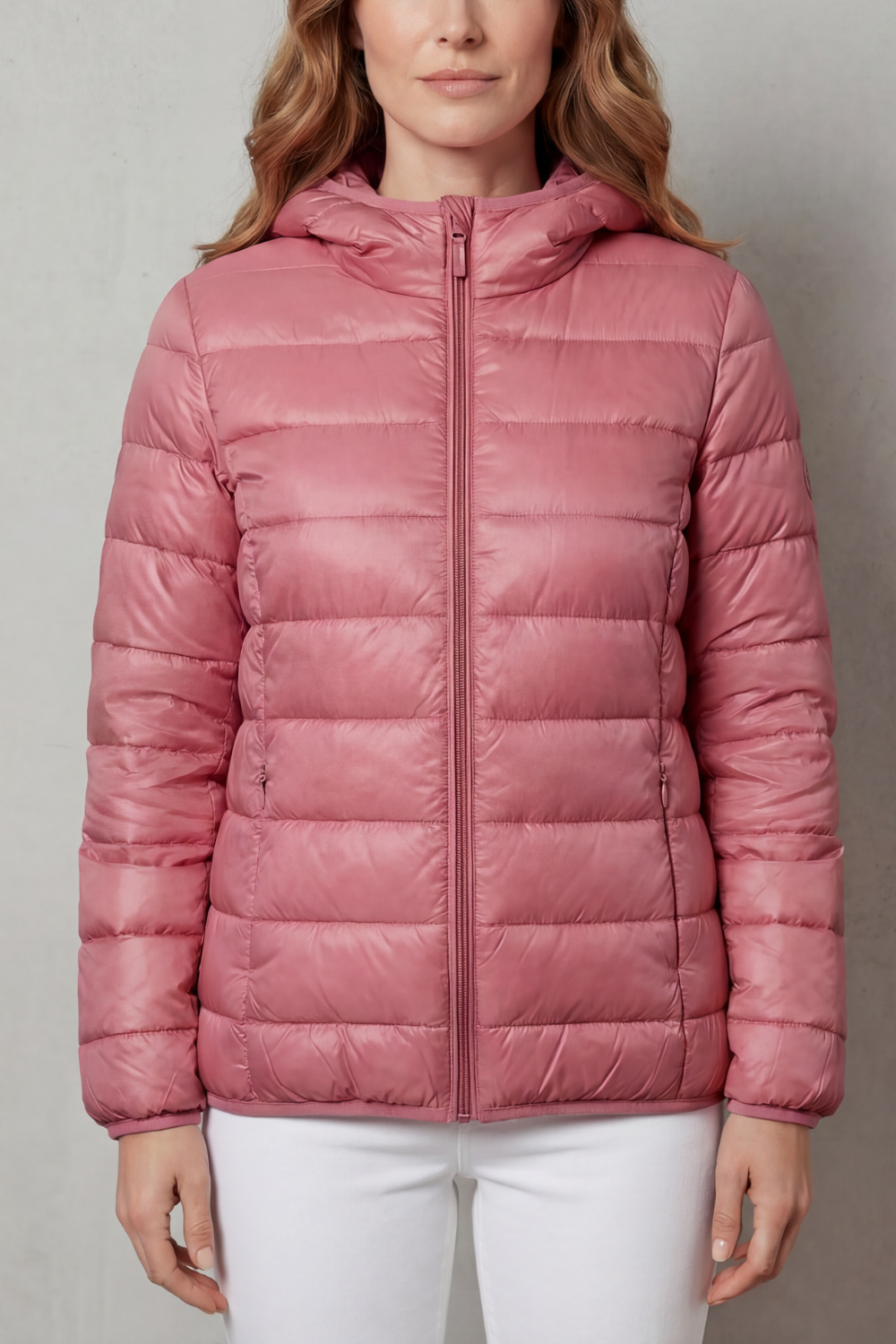 Woman wearing a lightweight waterproof rain coat. Layering outerwear for all-season travel and active adventures.