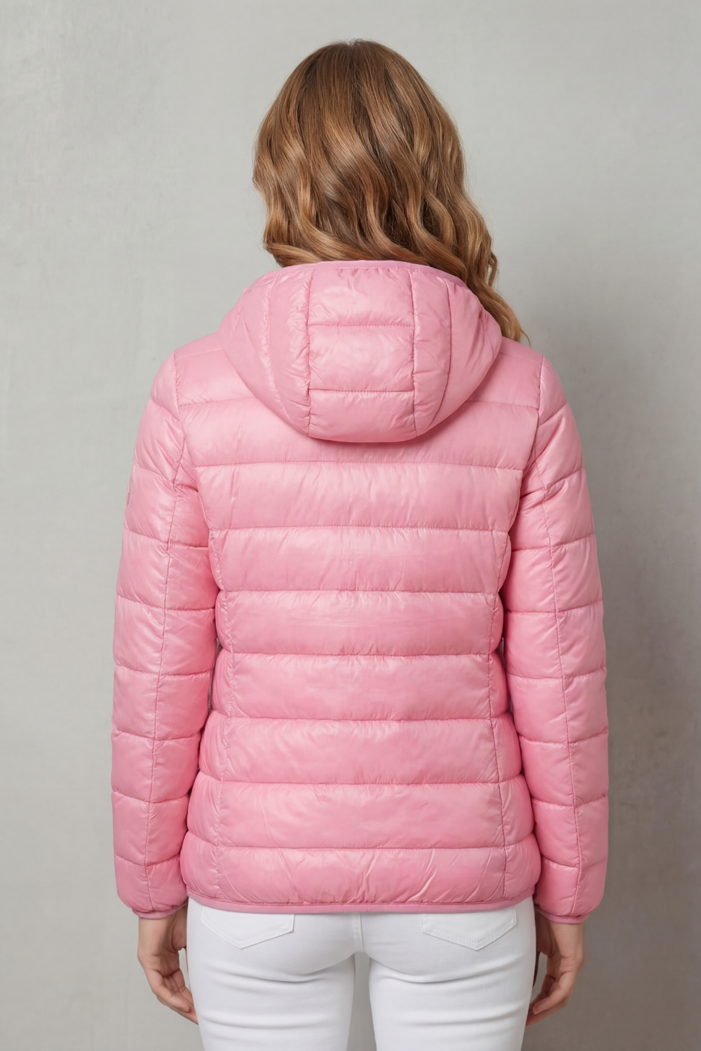 Lightweight women's travel rain coat. Waterproof outerwear for easy layering and all-weather protection on trips.
