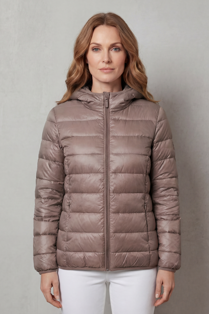 Functional women's waterproof outerwear. All-season rain jacket designed for comfortable layering and travel.