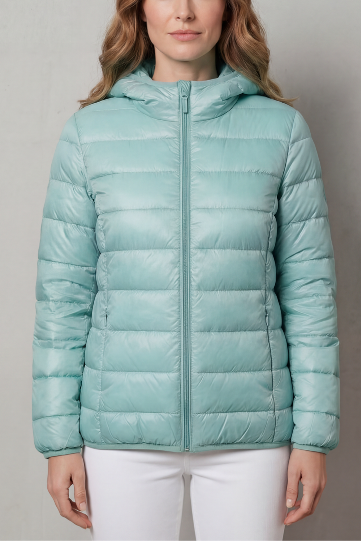 Packable women's waterproof rain coat. Lightweight travel outerwear, perfect for layering and unpredictable weather.