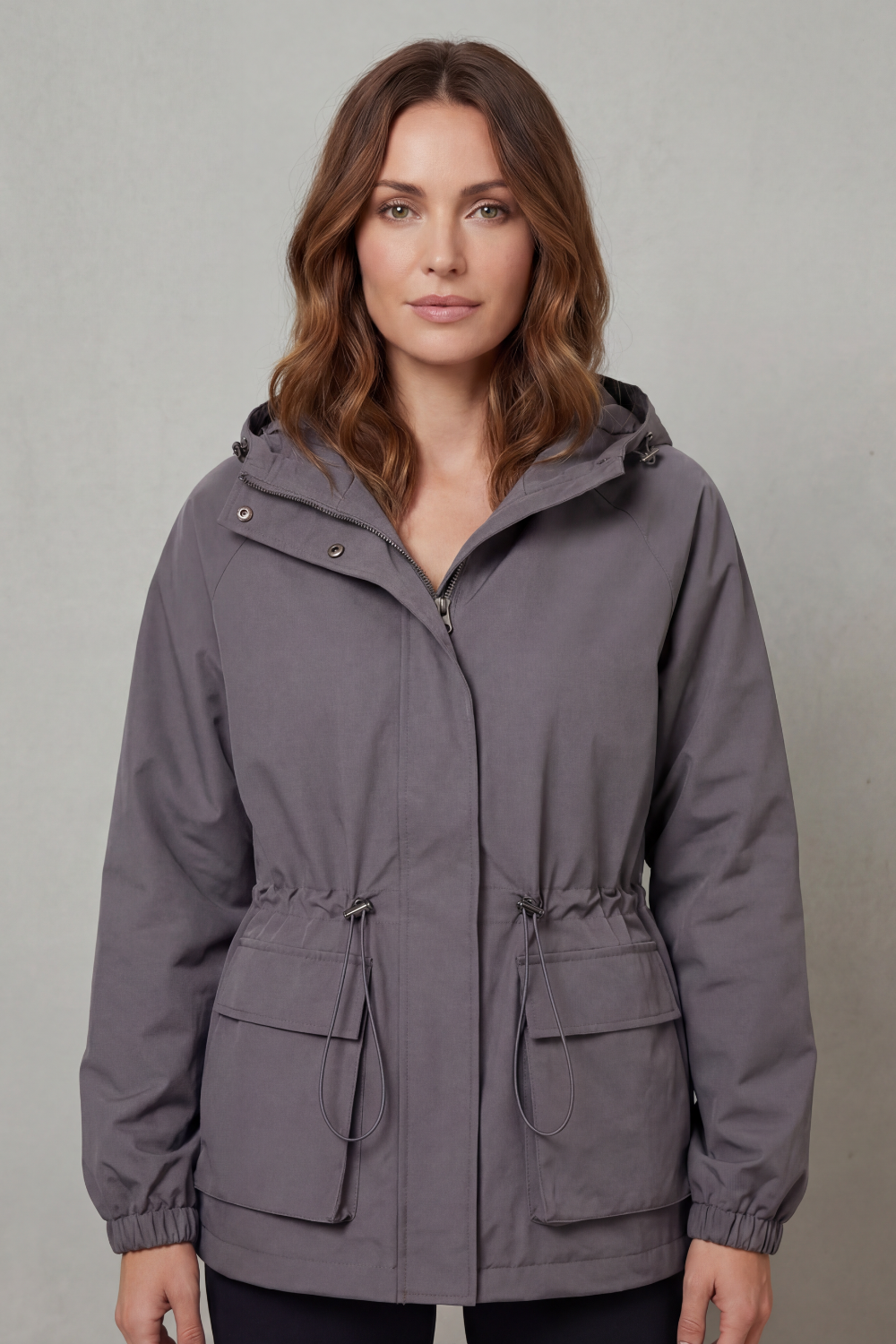 Durable women's waterproof utility jacket with drawstring for everyday adventures.