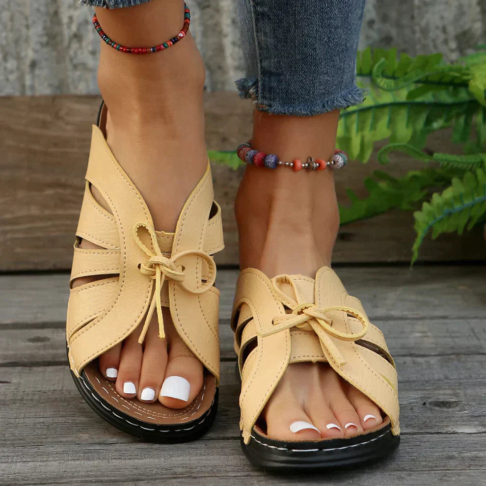 Trendy open-toe women's wedge sandals with a distinct knot detail, offering comfort & versatile summer fashion.