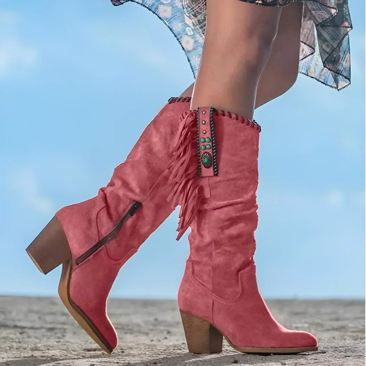 Statement women's Western boots; knee-high with elegant fringe and tassel details on a block heel.