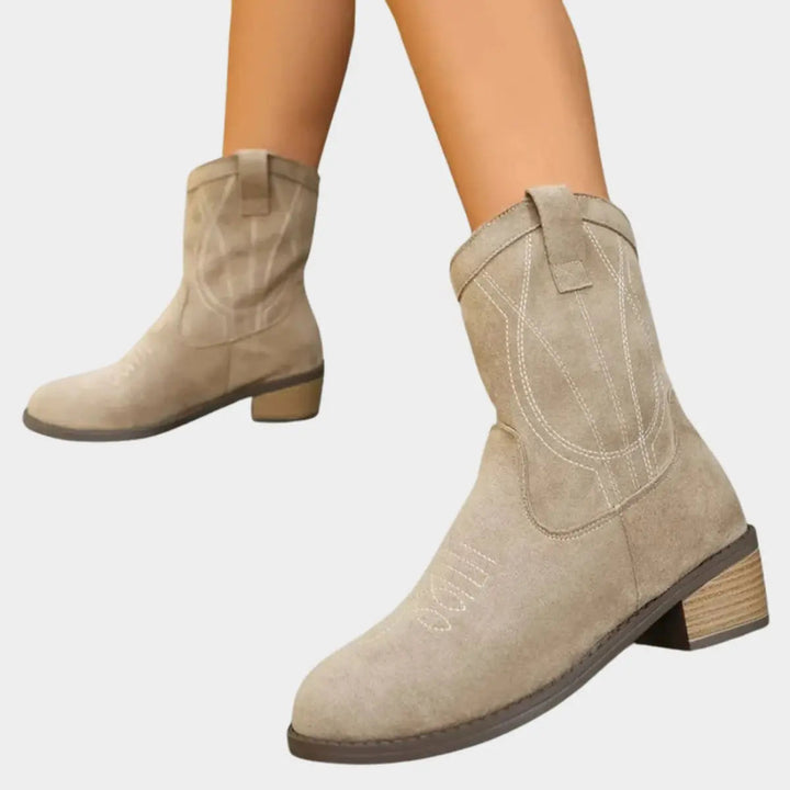 Classic women's cowboy ankle boots featuring a sturdy block heel and intricate Western stitching.