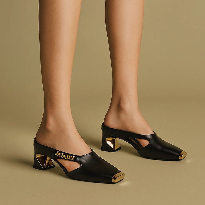 Stylish women's white block-heel mules with a unique square metallic toe and elegant gold chain detail, great for versatile looks.