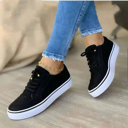 A woman wearing casual lace-up sneakers, perfect for everyday activities and errands.