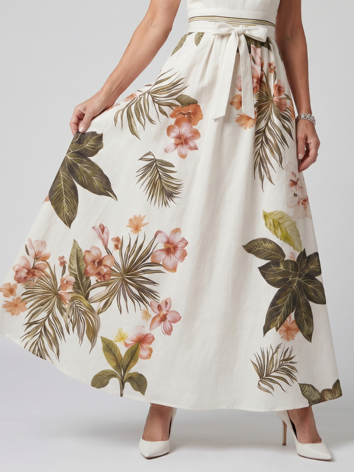 Women's elegant white maxi dress, featuring a draped halter neckline & botanical print panels. Ideal for summer fashion.