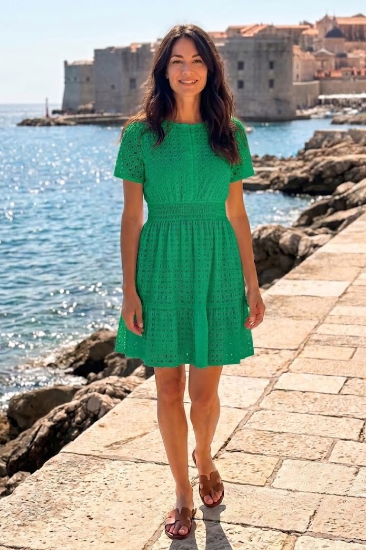 Elegant white women's eyelet mini dress, featuring romantic flutter sleeves and a flowy tiered skirt.