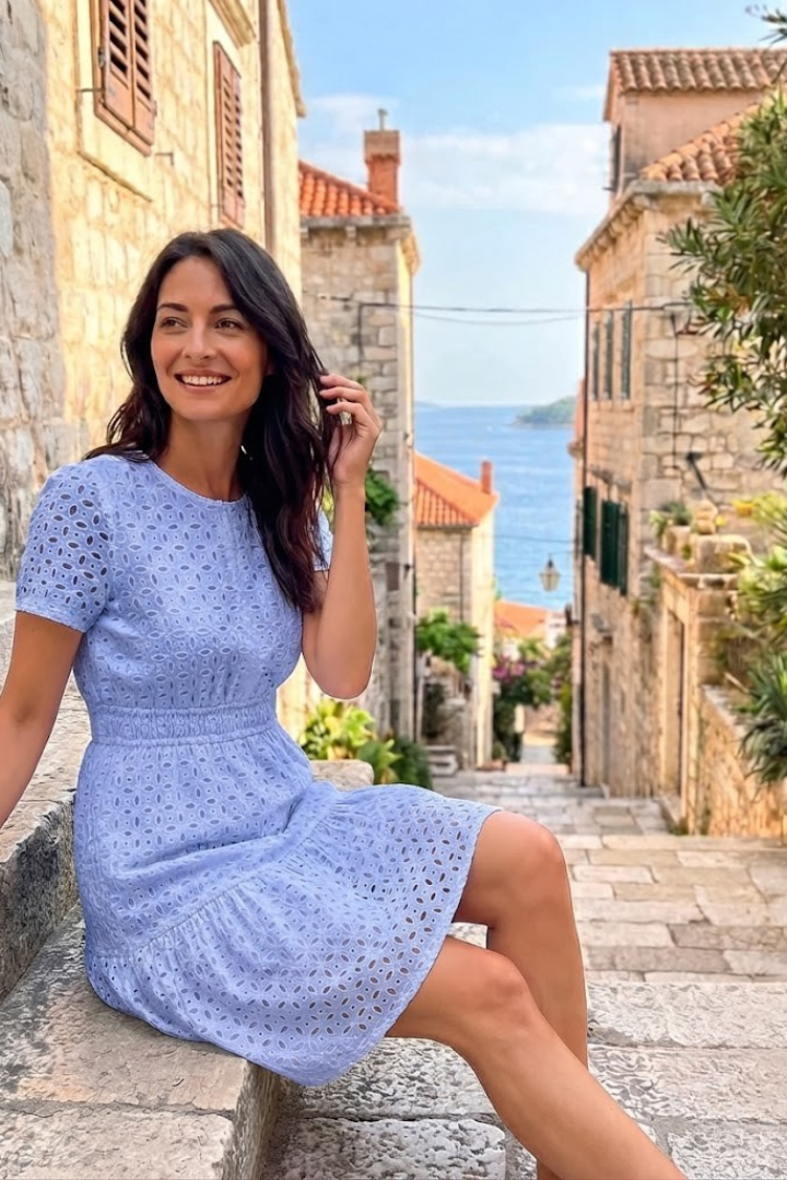 Versatile women's eyelet mini dress with flutter sleeves in white, green, or blue for summer casual days.
