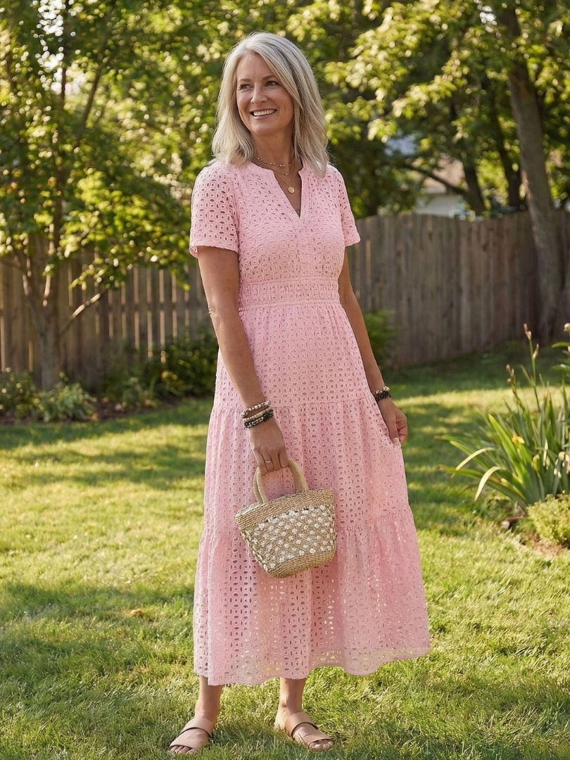Women's white eyelet tiered midi dress with short sleeves, perfect for a comfortable summer day look.