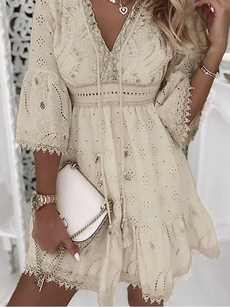 Women's white eyelet V-neck mini dress with long flared sleeves. Perfect for summer casual wear & vacation style.