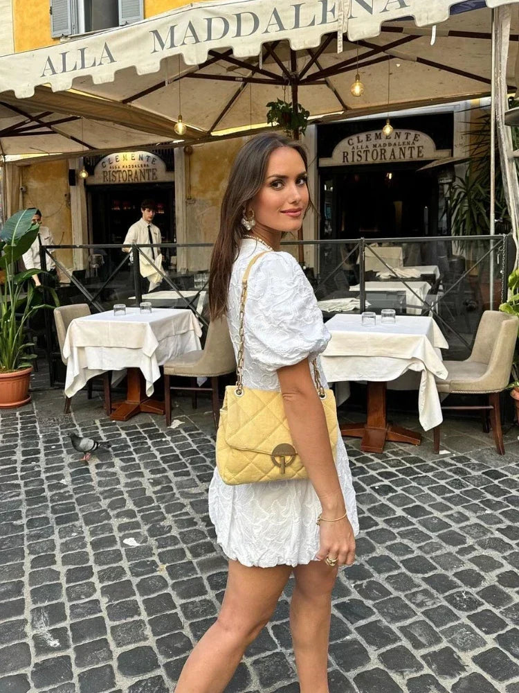 White floral print mini dress for women, flattering cut and trendy puff sleeves for chic summer fashion.