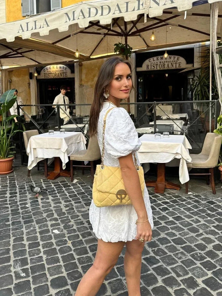 White floral print mini dress for women, flattering cut and trendy puff sleeves for chic summer fashion.